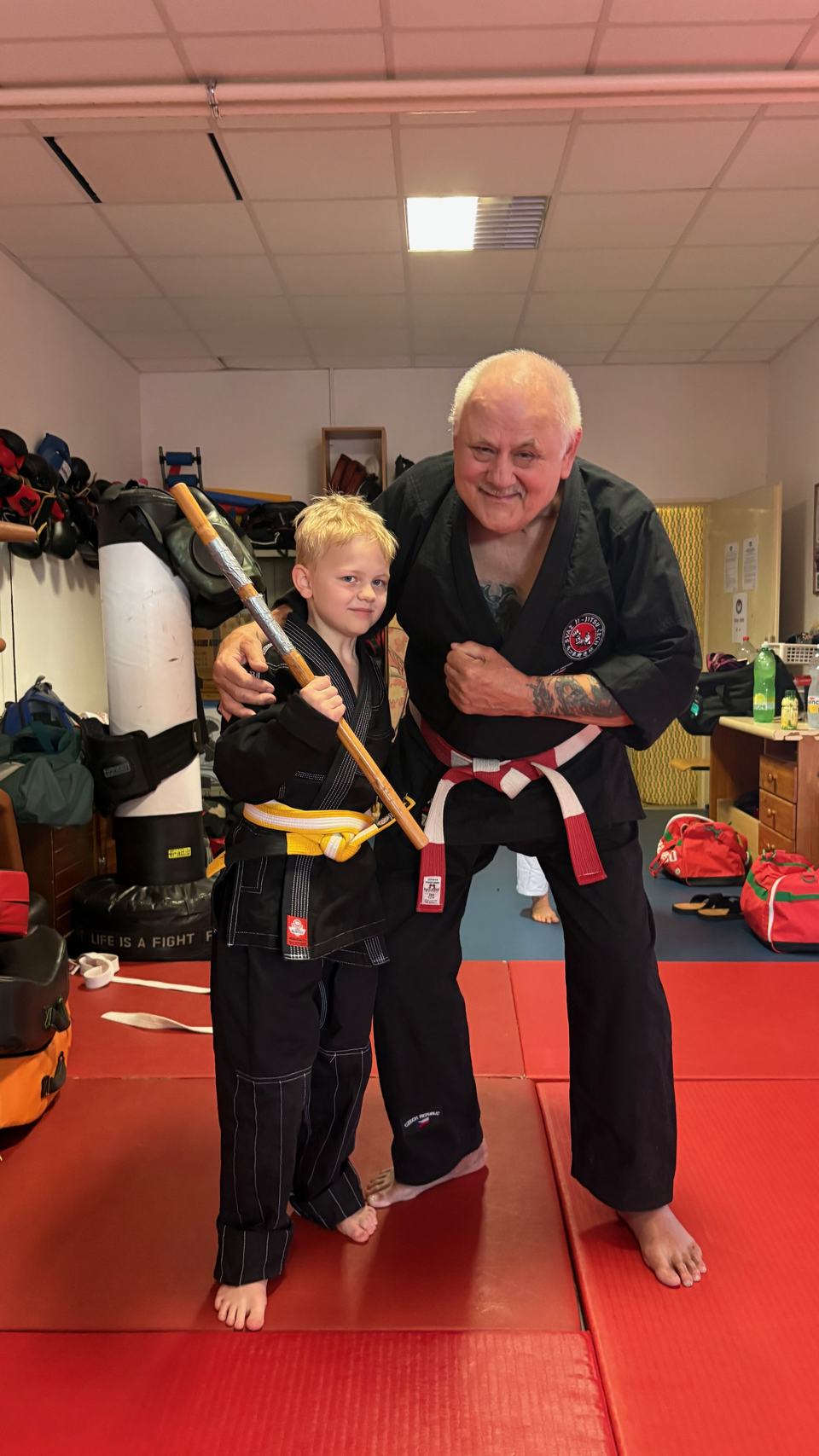 A young student with a stick and a coach
