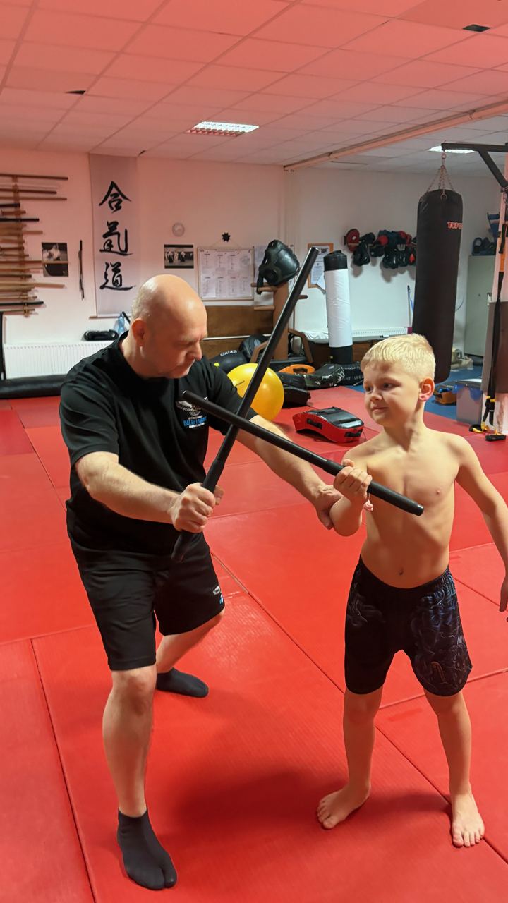 Escrima stick drill, an adult with a child